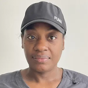 ganelle is wearing a grey merry maids uniform